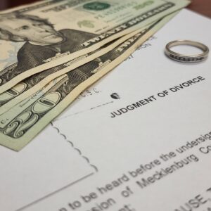 Currency on a document with a wedding band