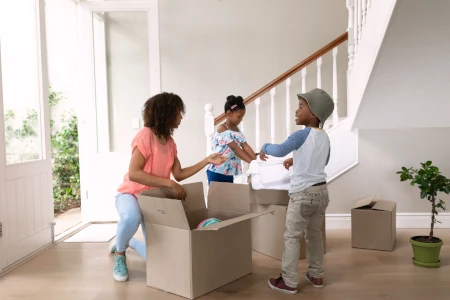 Woman with her two young children packing boxes to move to another town. Can You Relocate with a Child Custody Order?