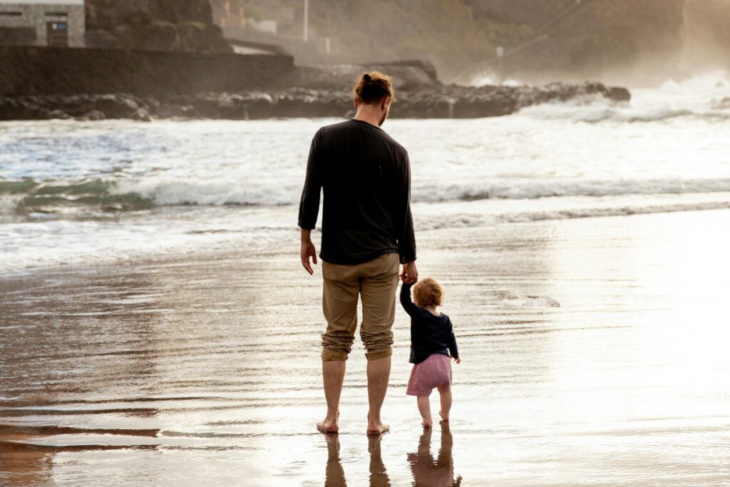 father and child on beach