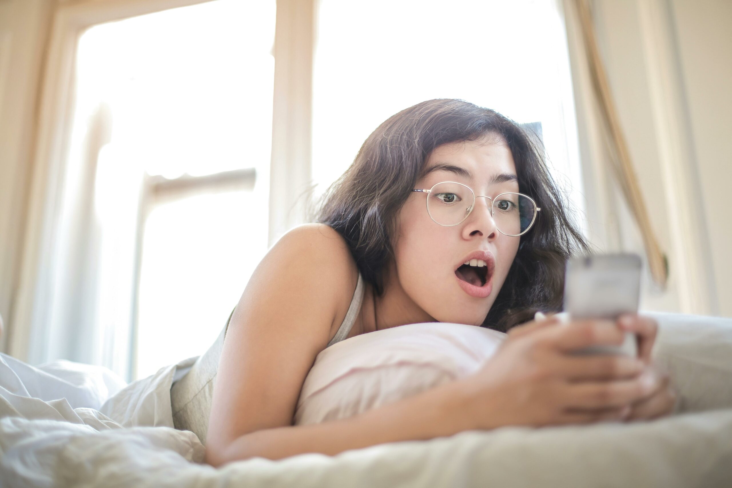 shocked woman looking at phone